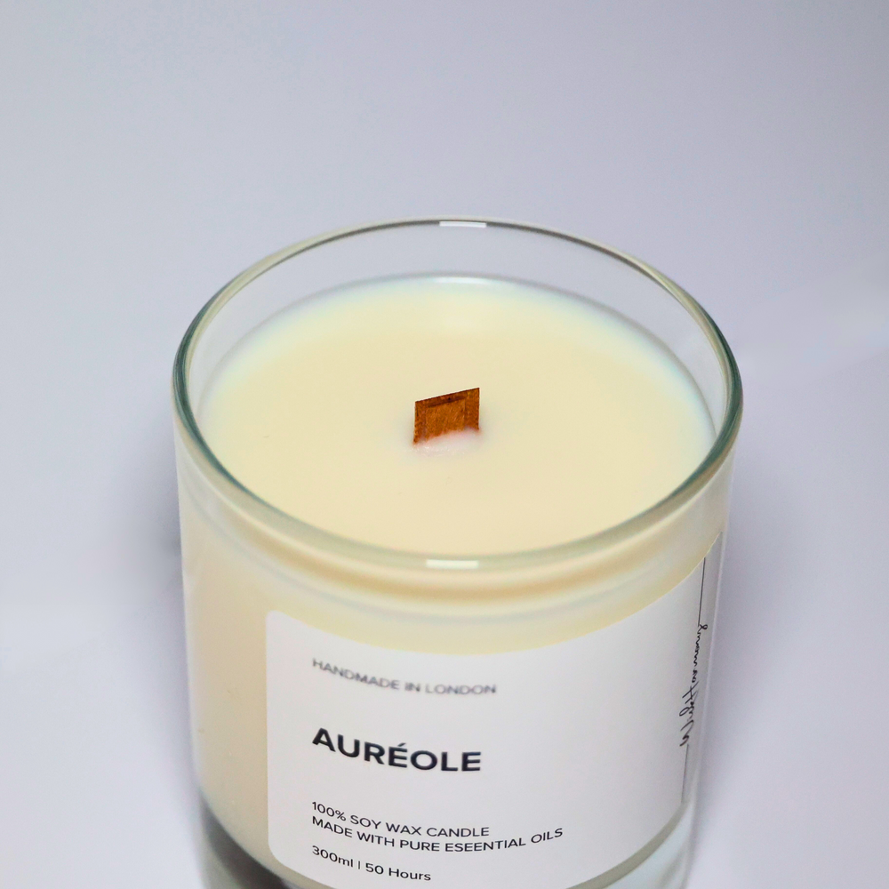 Top view of Auréole candle showing wooden wick and creamy soy wax, crafted with essential oils in a clear glass jar