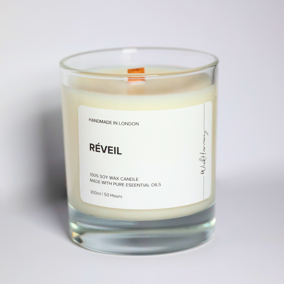 Réveil essential oil soy candle in a 300ml clear glass jar with wooden wick, handmade in London by WickHarmony. Made with basil, lemon, orange, and spearmint oils.