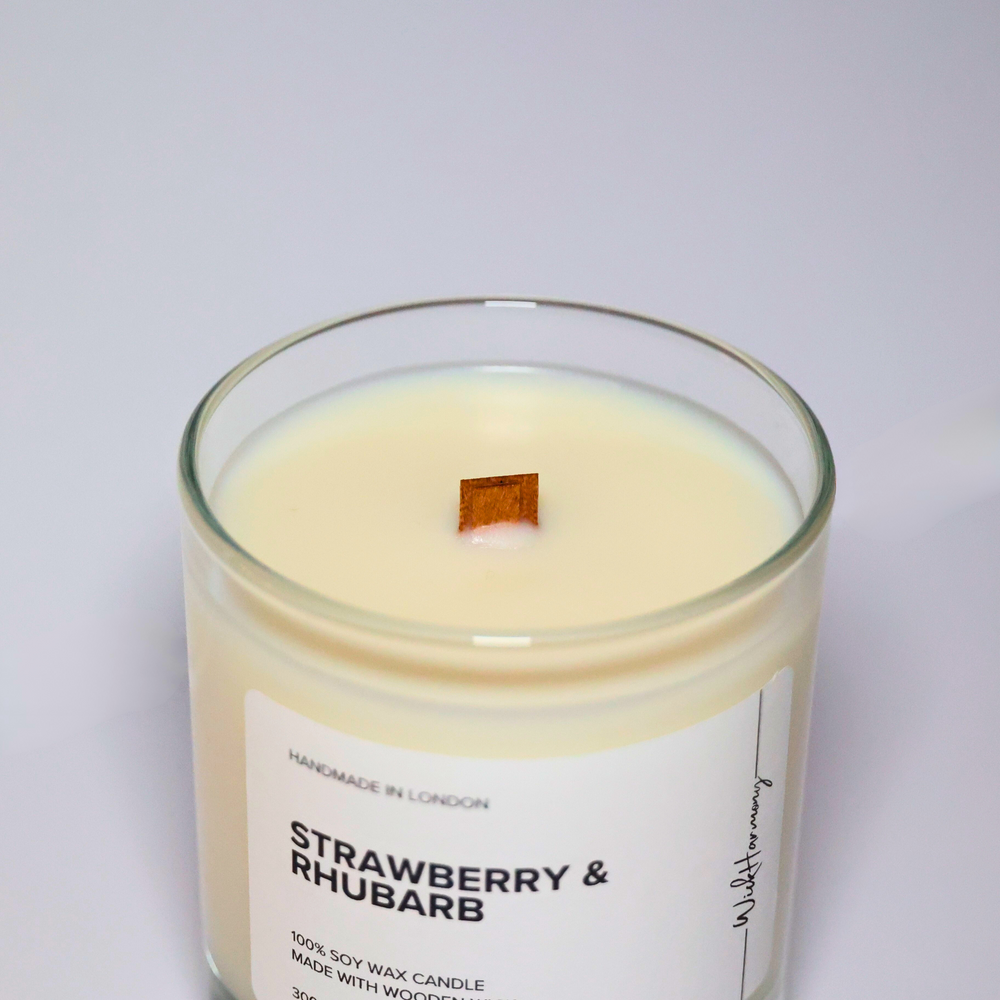 Top view of Strawberry & Rhubarb soy candle showing wooden wick and creamy soy wax in a clear glass jar