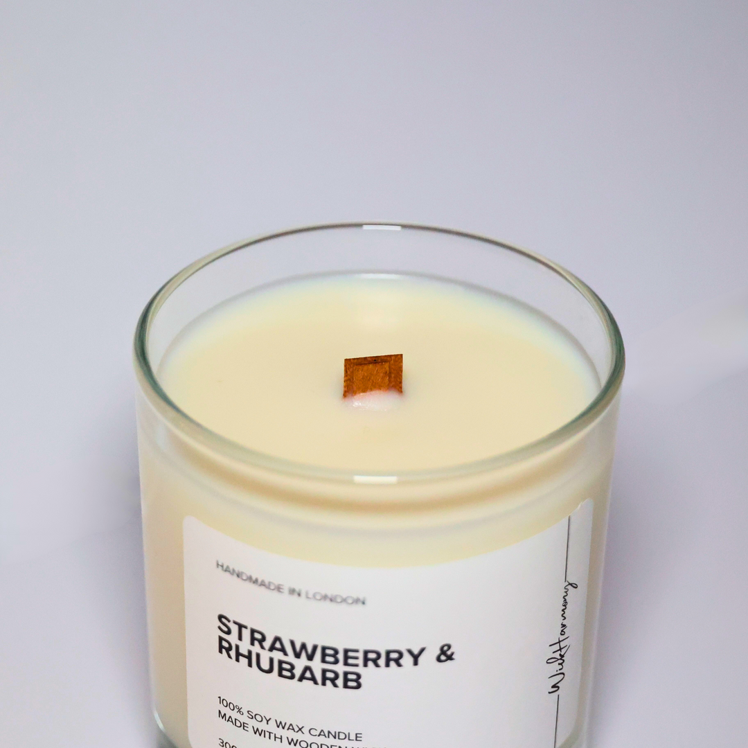 Top view of Strawberry & Rhubarb soy candle showing wooden wick and creamy soy wax in a clear glass jar