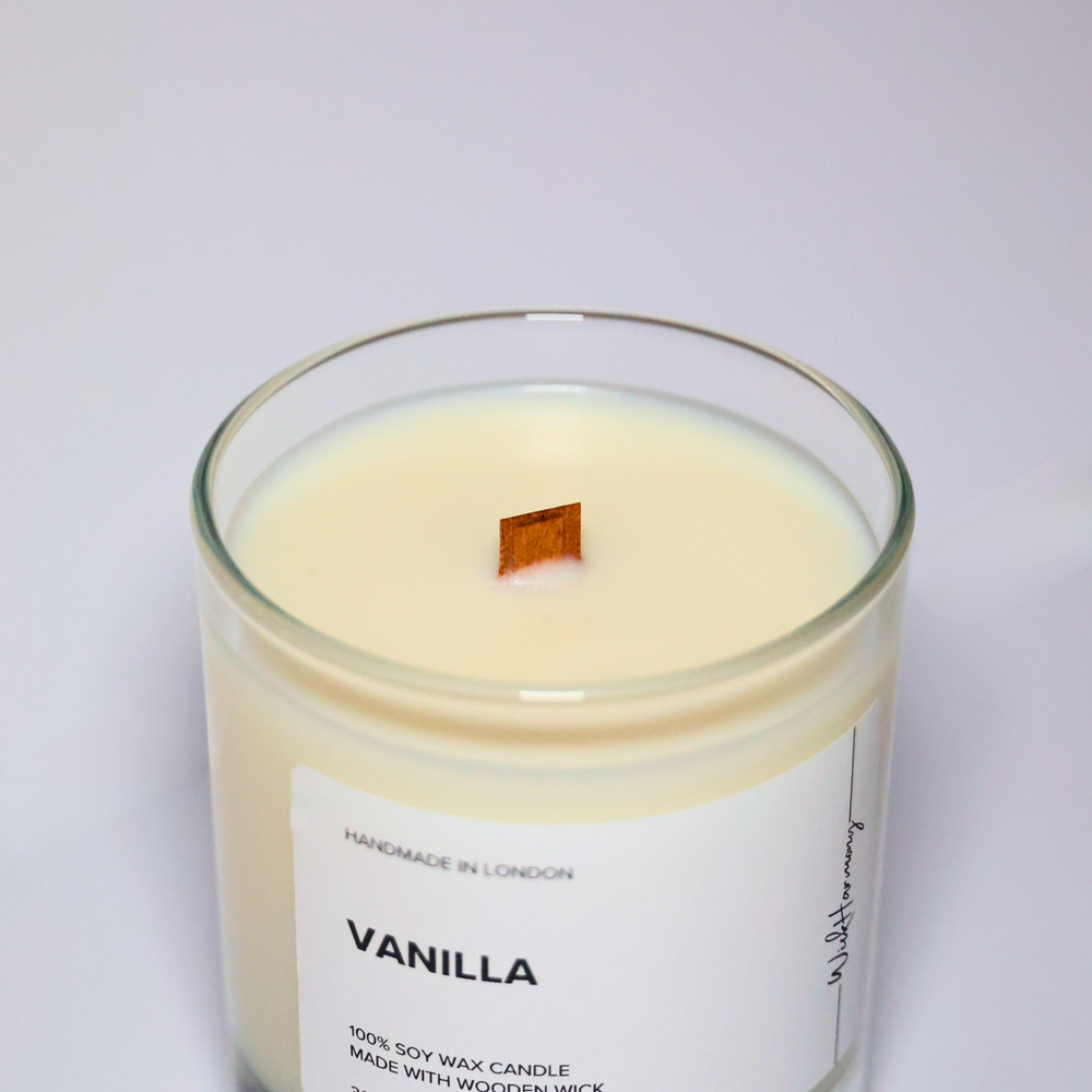 Top view of Vanilla soy candle showing wooden wick and creamy soy wax in a clear jar