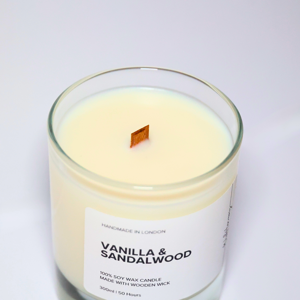 Top view of Vanilla and Sandalwood soy candle showing wooden wick and creamy soy wax in a clear jar